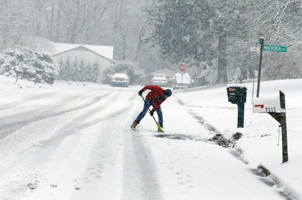 PHOTO: David Rigby shovels his driveway during a snowstorm, Jan. 31, 2021, in Mechanicsville, Va.