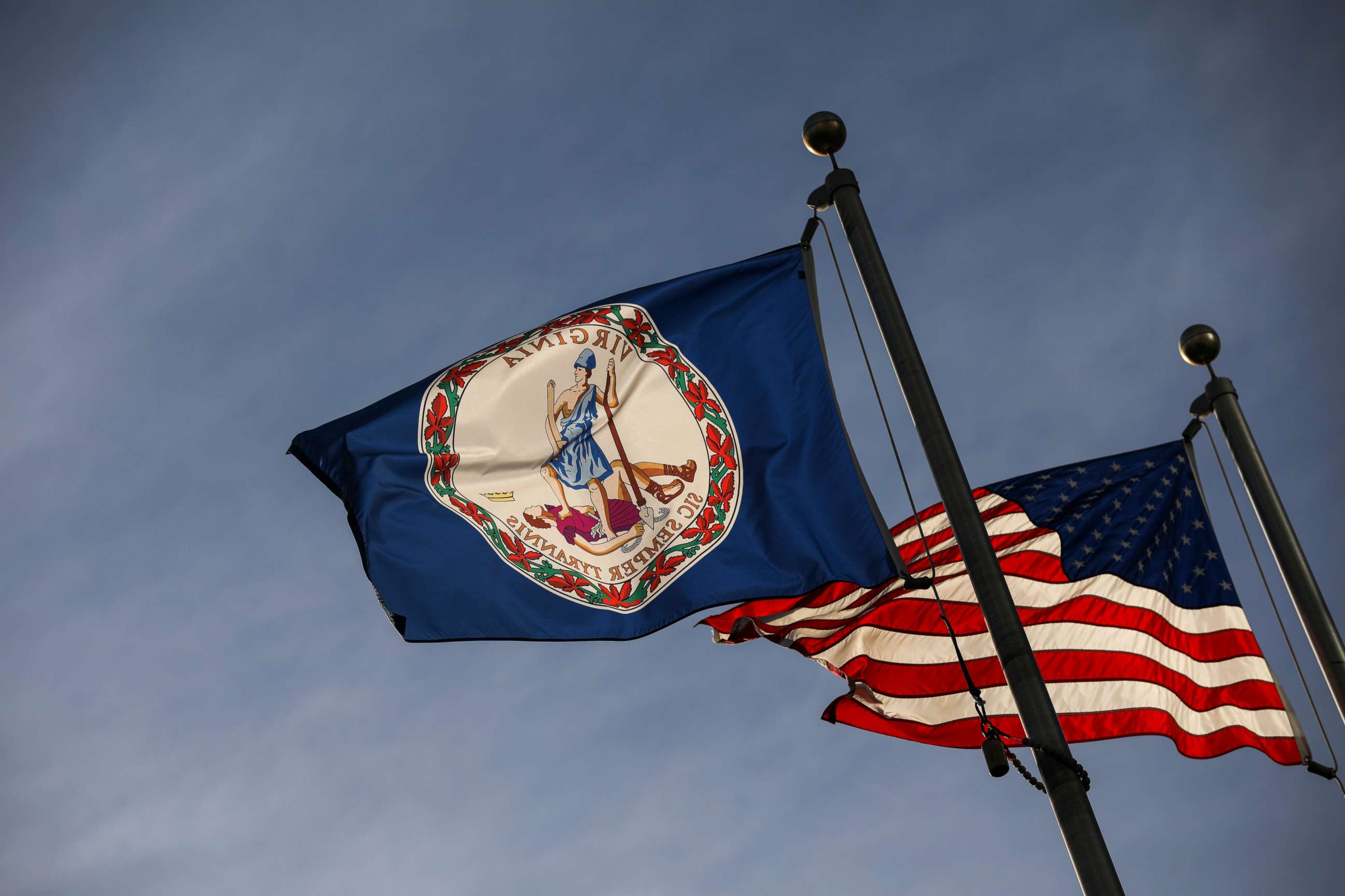 PHOTO: The Virginia state flag and the American flag fly near the Virginia State Capitol, Feb. 9, 2019, in Richmond, Va.