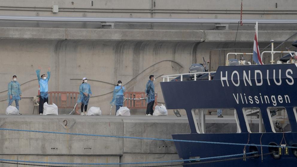 PHOTO: Persons with protective suits wait in line after disembarking from the hantavirus-stricken cruise ship MV Hondius docked in the port of Granadilla de Abona on the island of Tenerife in Spain's Canary Islands, May 11, 2026.