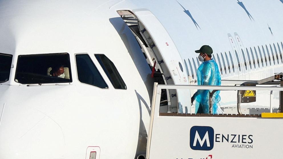 PHOTO: A passenger from the cruise ship MV Hondius, which was affected by a hantavirus outbreak, boards a plane to travel to the Netherlands, at Tenerife Sur airport, Canary Islands, Spain, May 11, 2026. 
