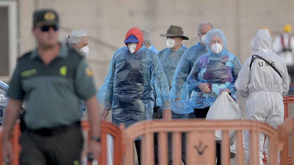 PHOTO: Passengers of the hantavirus-stricken cruise ship MV Hondius wait to board buses after disembarking in the port of Granadilla de Abona on the island of Tenerife in Spain's Canary Islands, May 11, 2026. 