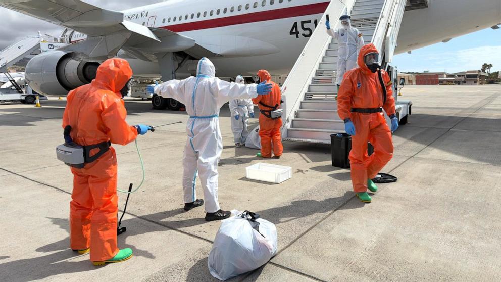 PHOTO: A Spanish passenger is sprayed with disinfectant by Spanish government officials before boarding a plane after disembarking from the hantavirus-stricken cruise ship MV Hondius at Tenerife airport in the Canary Islands, Spain, May 10, 2026.
