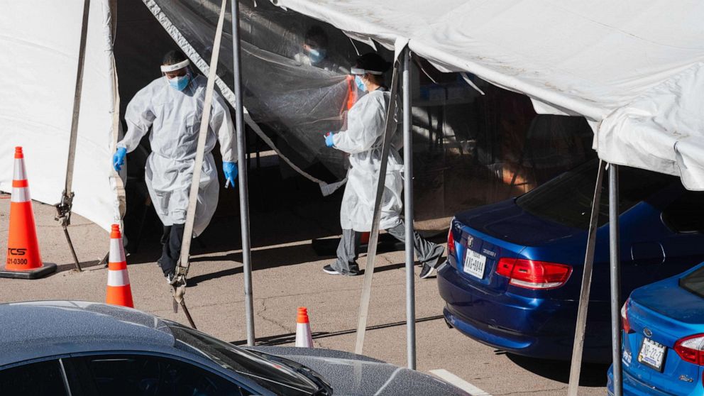 PHOTO: Medical workers provide free Covid-19 tests at a state run drive-thru testing site on the University of Texas El Paso campus in El Paso, Texas, November 14, 2020.