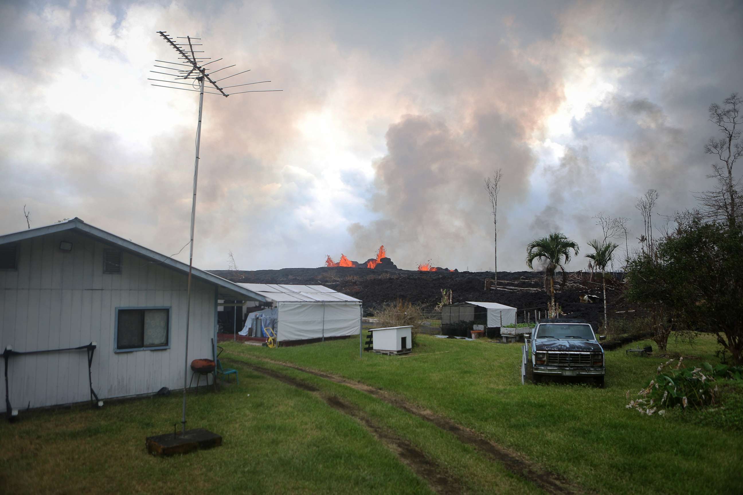PHOTO: Lava from a fissure erupts on a residence in Leilani Estates, on Hawaii's Big Island, May 26, 2018 in Pahoa, Hawaii. 
