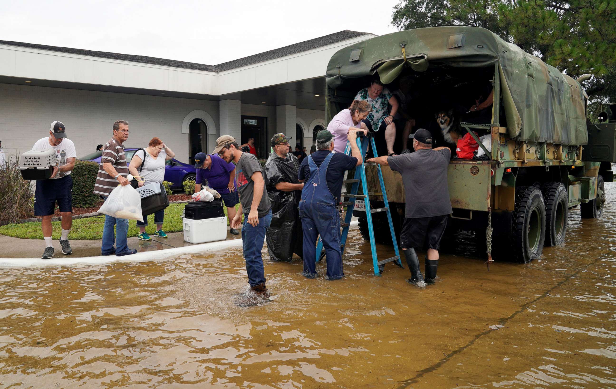 PHOTO:Volunteers load people into a military truck to evacuate them from flood waters from Hurricane Harvey in Dickinson, Tex., Aug. 27, 2017. 