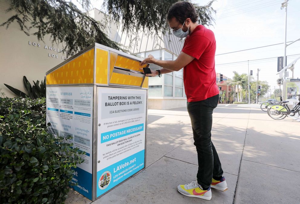 PHOTO: Voter Cody Crump places his ballot in a mail-in ballot drop box outside of a library ahead of Election Day, Oct. 5, 2020, in Los Angeles.