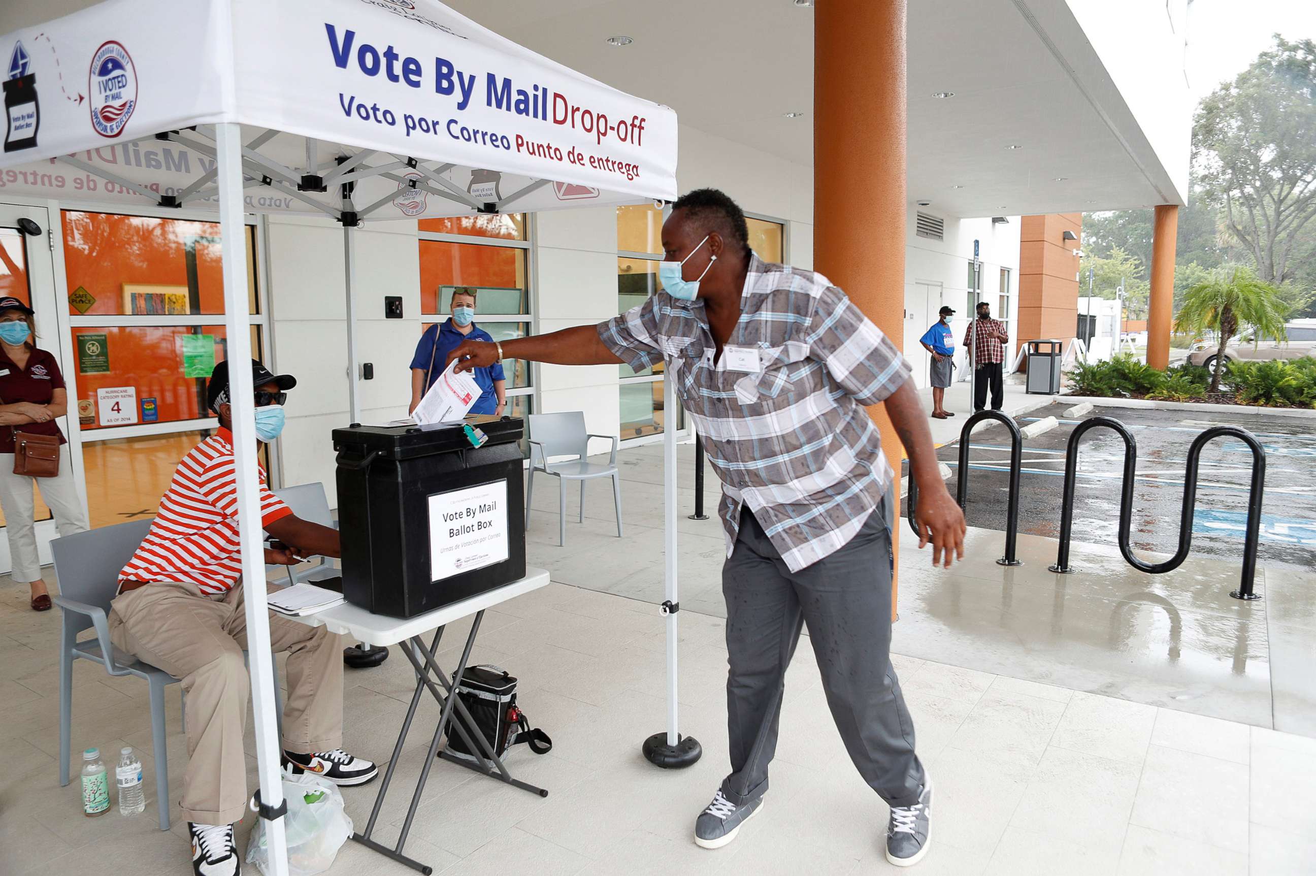 PHOTO: A poll worker casts a mail-in ballot for a disabled driver on the last day of early voting for the U.S. presidential election at the C. Blythe Andrews, Jr. Public Library in East Tampa, Fla., Aug. 16, 2020.
