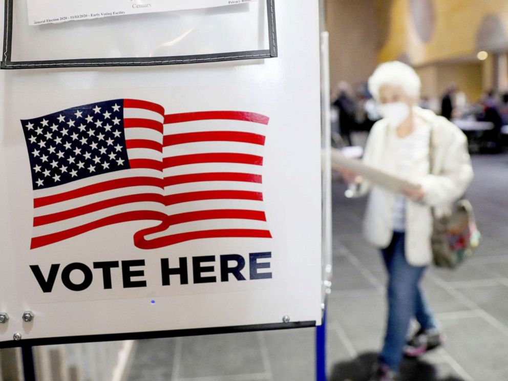 PHOTO: A voter walks towards a booth to fill out her ballot during the in-person early voting at a polling station in Lincoln Center in New York, Oct. 24, 2020.