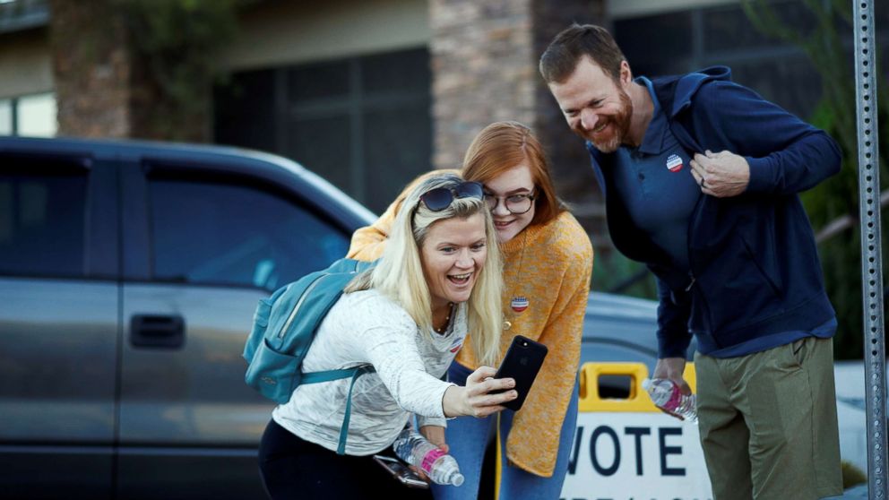 PHOTO: Victoria Leach, 18, takes a selfie with her parents Tricia Leach and Marc Leach after voting at a polling station in Carefree, Ariz., Nov. 6, 2018.