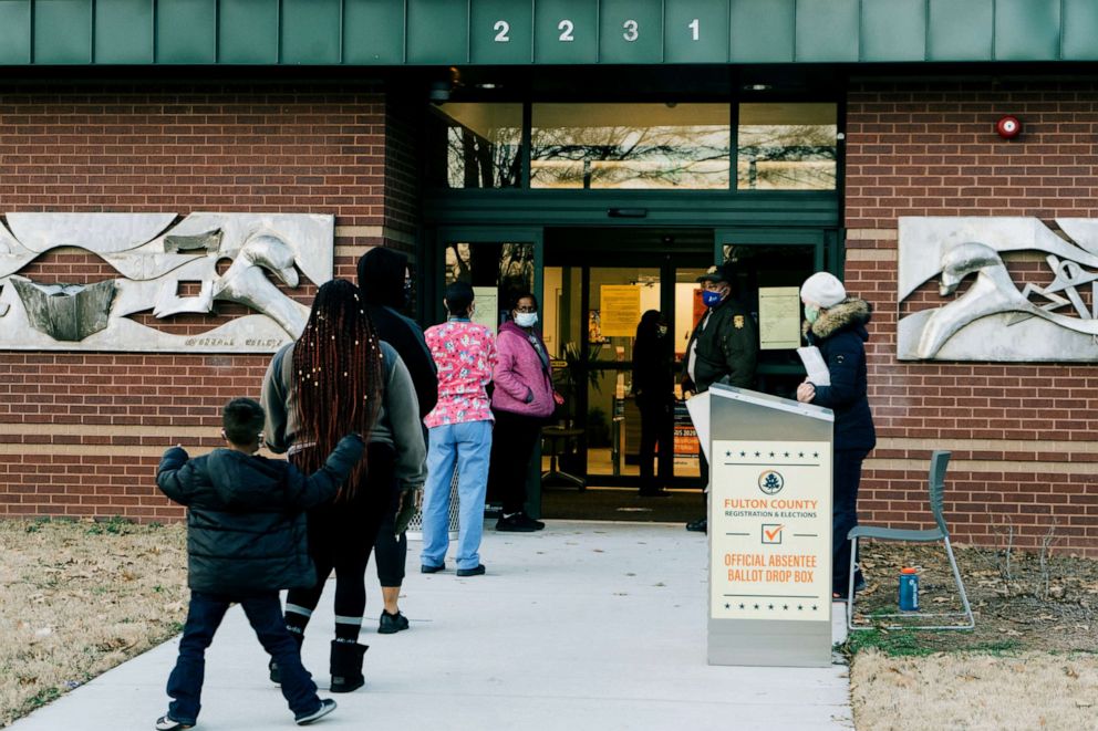 PHOTO: Residents wait in line to cast ballots for the Senate runoff elections at a polling location in Atlanta, Jan. 5, 2021.