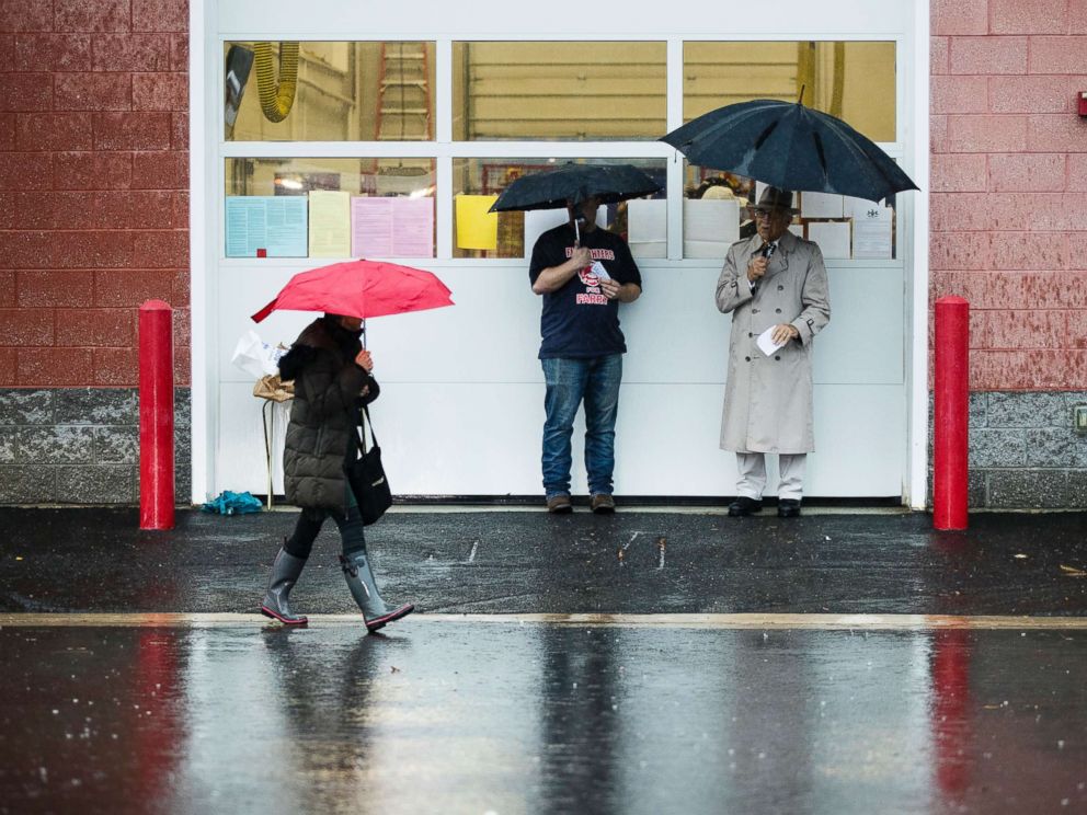 PHOTO: A voter walks in the rain from her polling place after voting in Langhorne, Pa., Nov. 6, 2018.