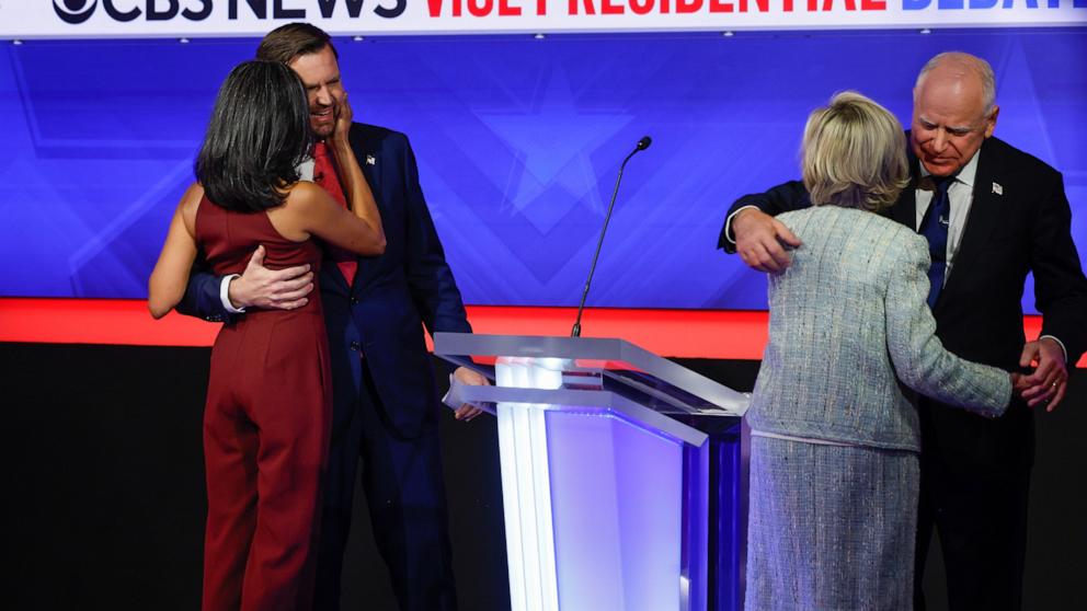 PHOTO: Democratic vice presidential candidate Minnesota Gov. Tim Walz and his wife Gwen Walz (R) and  Republican vice presidential candidate Sen. JD Vance and his wife Usha Vance embrace after their debate, Oct. 1, 2024 in New York City. 