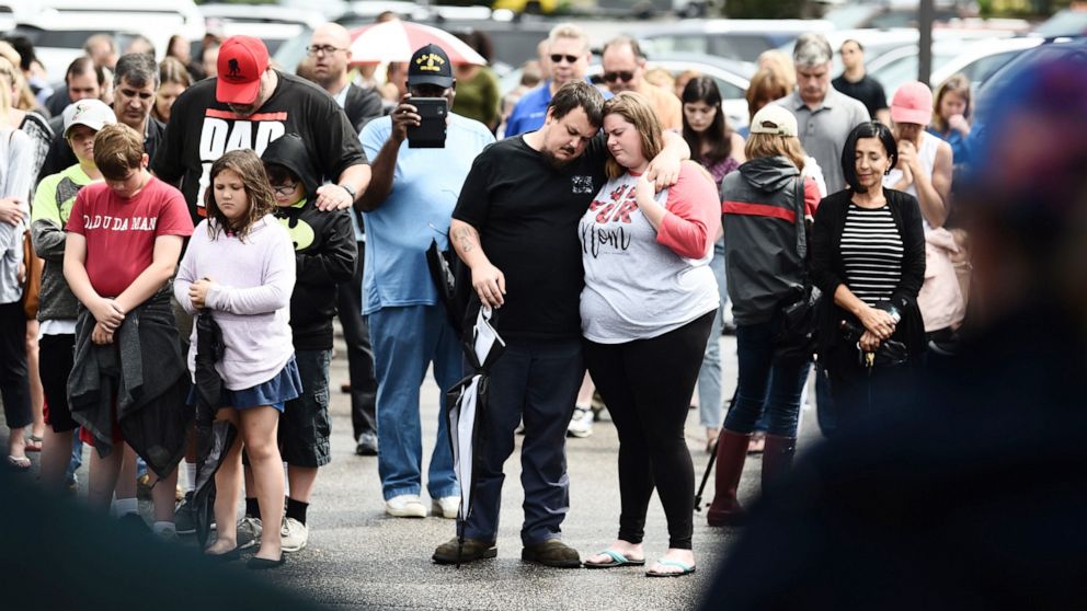 PHOTO: Mourners pray on June 1, 2019, for the victims of the mass shooting, during an improvised vigil in a parking lot of a shopping center in Virginia, Beach, Va.