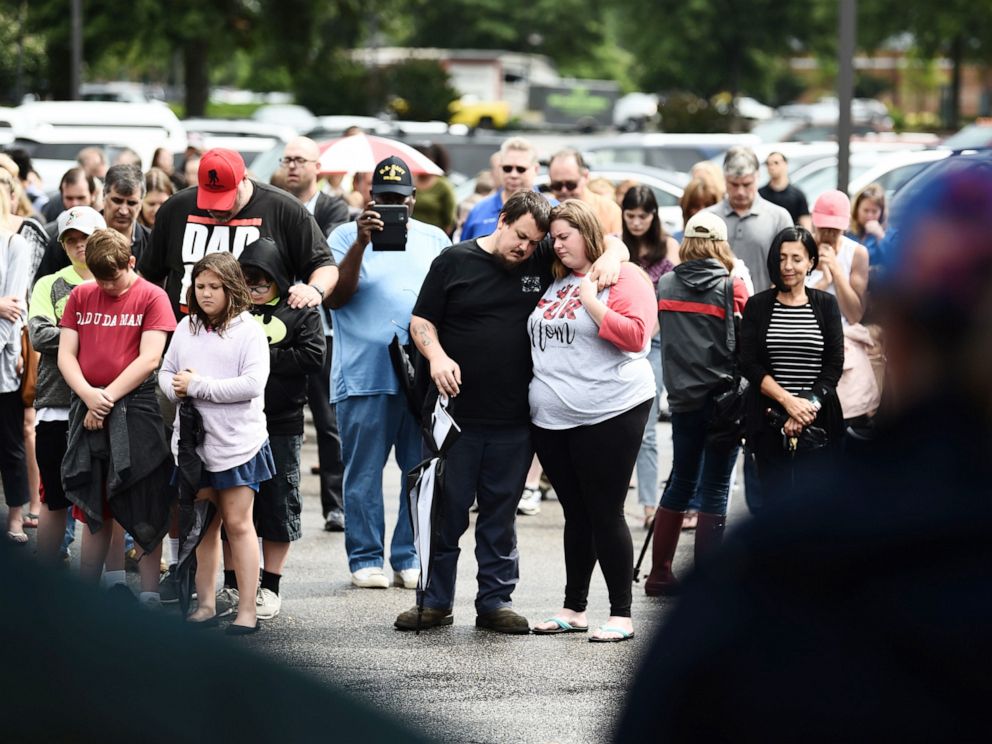 PHOTO: Mourners pray on June 1, 2019, for the victims of the mass shooting, during an improvised vigil in a parking lot of a shopping center in Virginia, Beach, Va.
