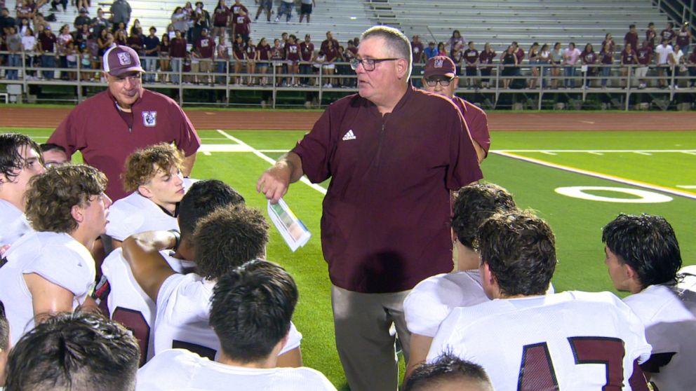 PHOTO: Head coach Wade Miller speaks to the Uvalde High School football team after a game in Uvalde, Texas.