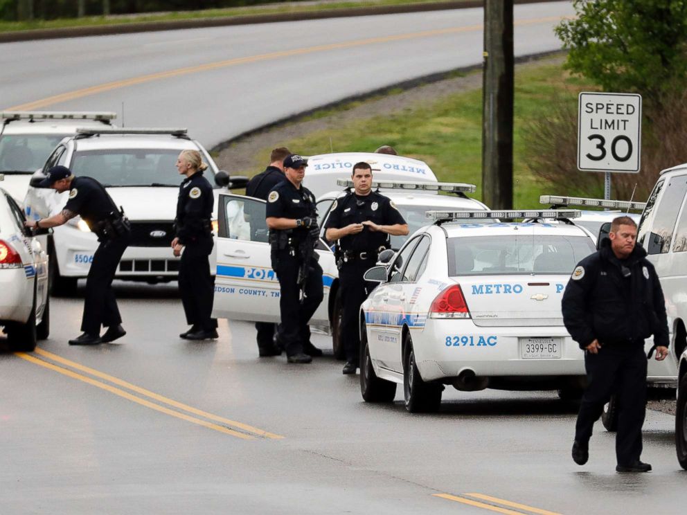 PHOTO: Nashville police officers gather alongside a wooded area as they search for a shooting suspect near a Waffle House restaurant, April 22, 2018, in Nashville, Tenn.