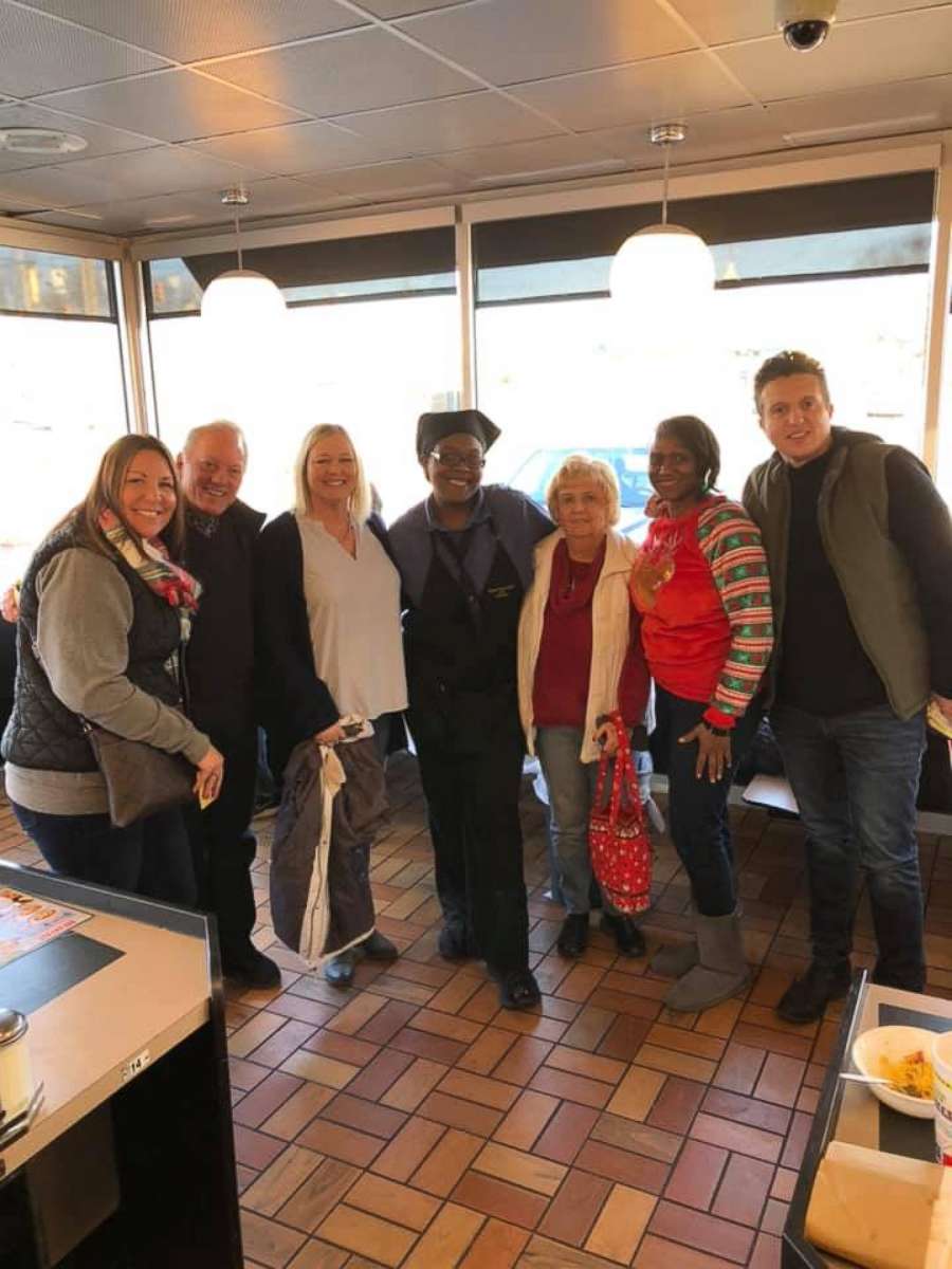 PHOTO: Customers in Woodlawn, Ohio, pose for a photo with a server at Waffle House after giving her $800 in tips as part of a "Shock and Claus" initiative.