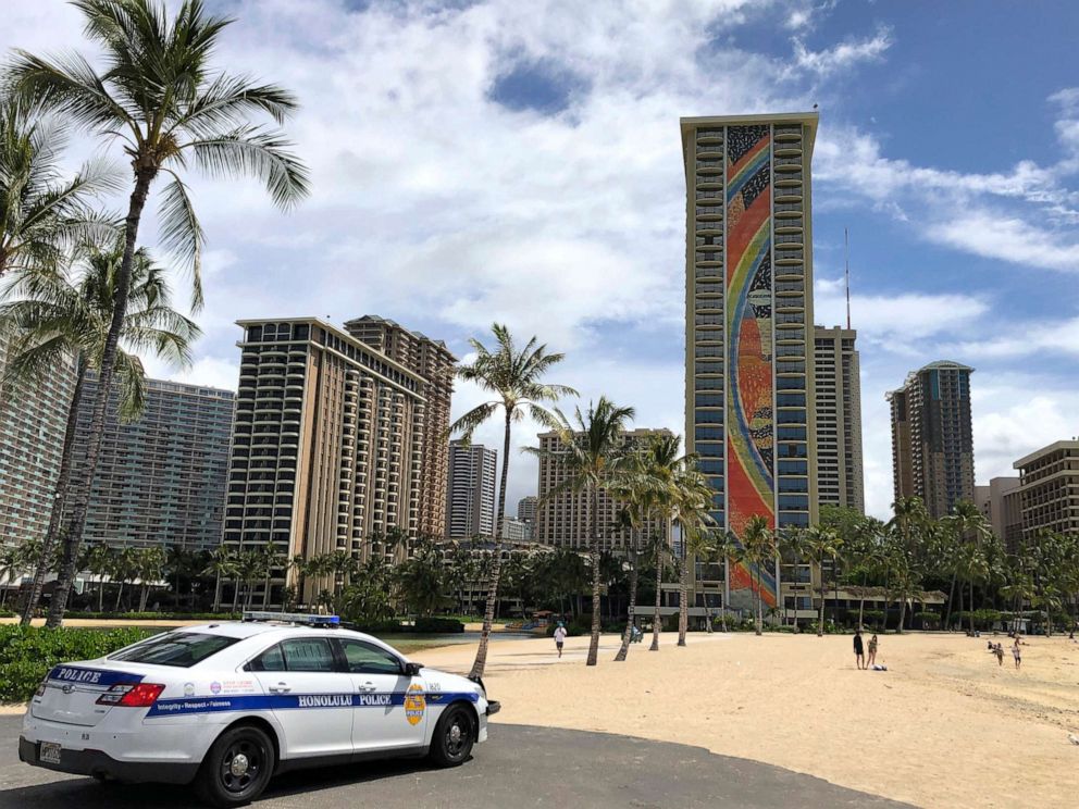 PHOTO:A police officer arrives to tell people to leave Waikiki Beach in Honolulu.
