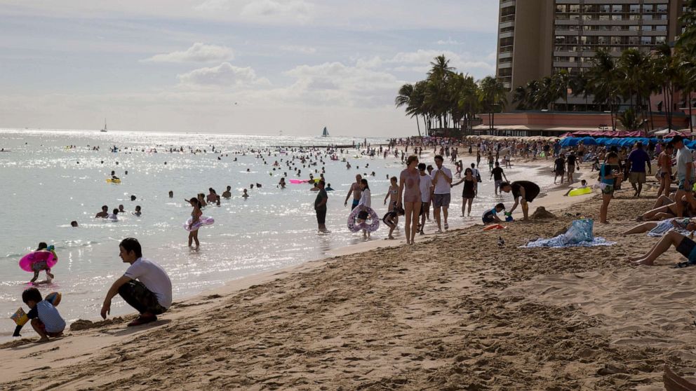 PHOTO: Both tourists and locals enjoy the day at Waikiki beach, Aug. 22, 2018, in Honolulu.