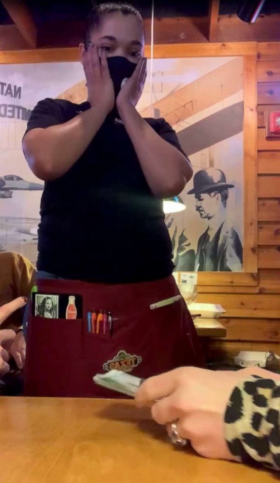 PHOTO: Denise Lewis reacts after being told she was receiving a $1,500 tip by customers at the Huber Heights Texas Roadhouse, in Huber Heights, Ohio, Dec. 16, 2020.