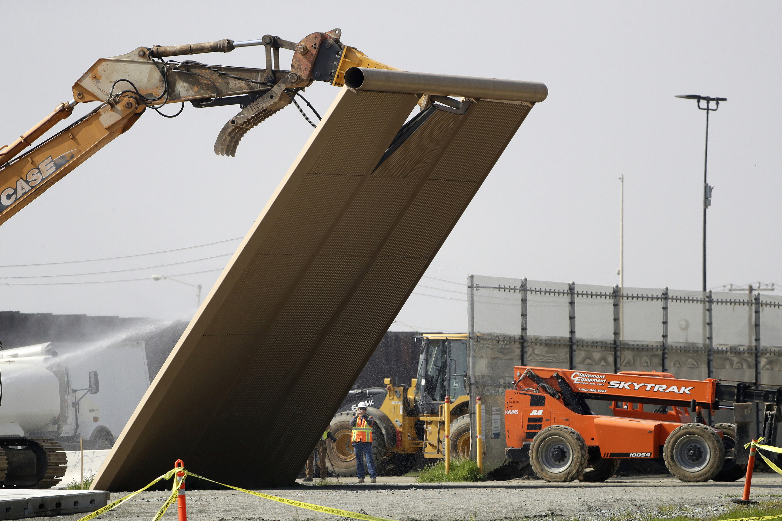 PHOTO: In this Feb. 27, 2019, file photo, a border wall prototype falls during demolition at the border between Tijuana, Mexico, and San Diego.
