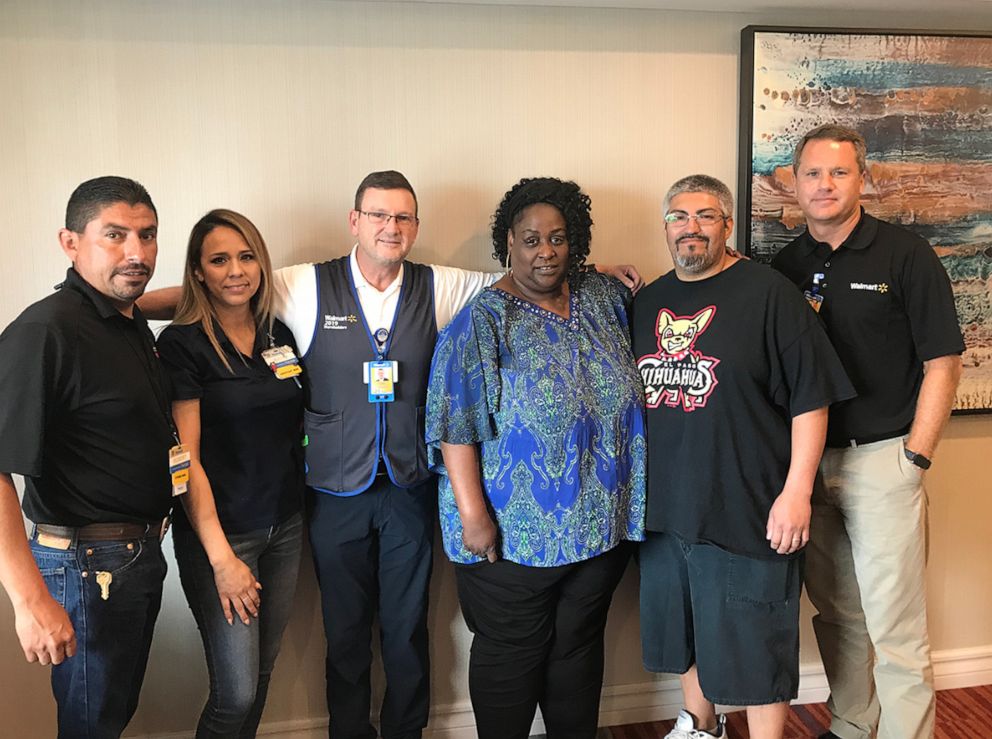 PHOTO: President and CEO of Walmart Inc., Doug McMillon, far right, is pictured with employees in a photo shared in his letter to associates on Aug. 6, 2019, after mass shootings at Walmart stores in El Paso, Texas and Dayton, Ohio.