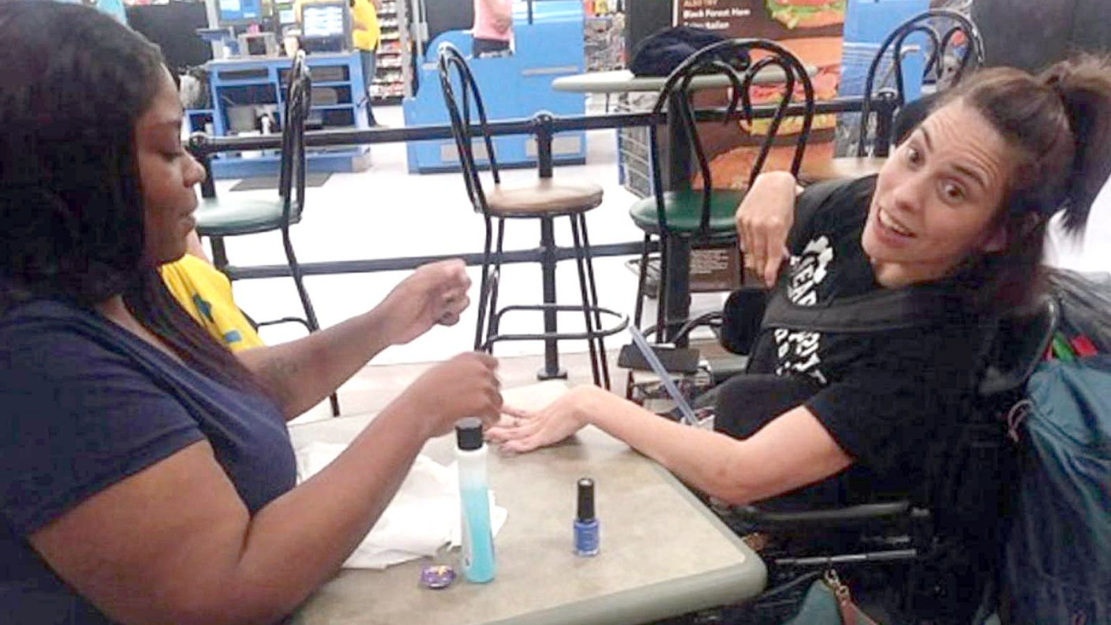 PHOTO: When Ebony Harris saw a woman, Angela Peters, in a wheelchair refused service from a nail salon near her work in Walmart, she decided to help.