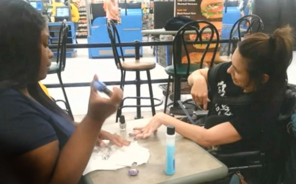 PHOTO: When Ebony Harris saw a woman, Angela Peters, in a wheelchair refused service from a nail salon near her work in Walmart, she decided to help.