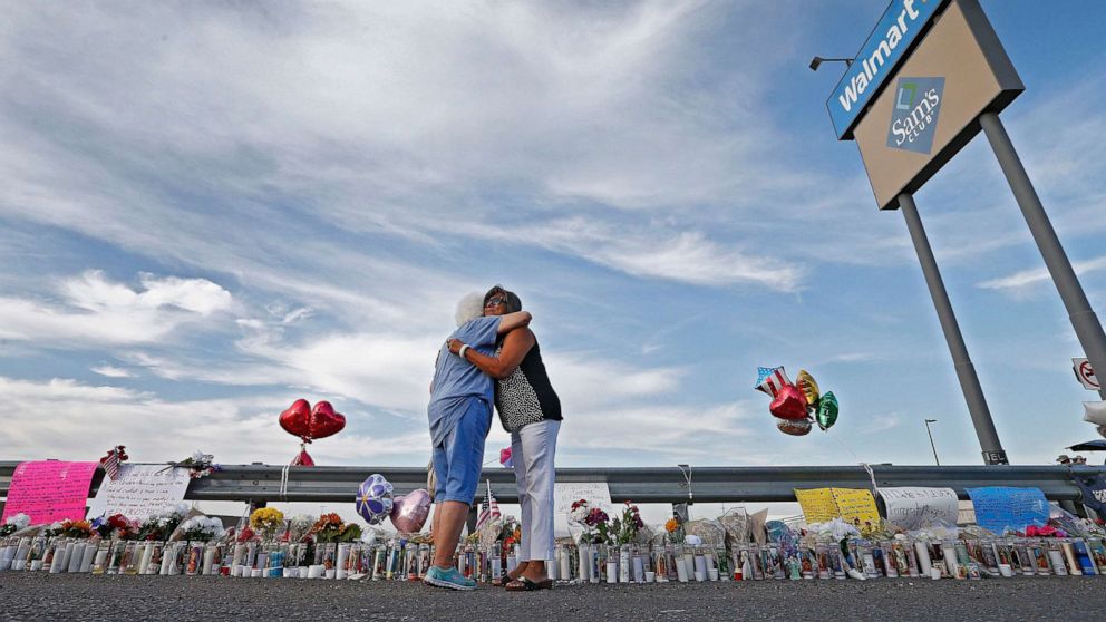 PHOTO: Emma Del Valle hugs Brenda Castaneda, right, while visiting the make-shift memorial outside the Walmart in El Paso, Texas, Aug. 5, 2019, following the mass shooting.