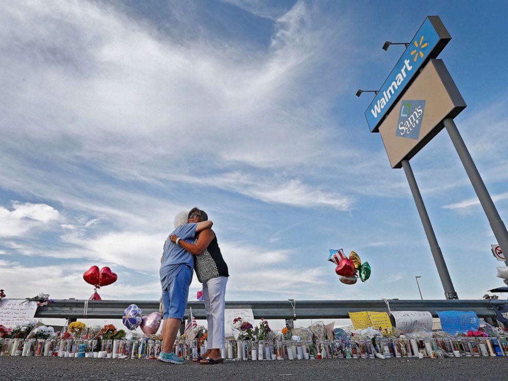 PHOTO: Emma Del Valle hugs Brenda Castaneda, right, while visiting the make-shift memorial outside the Walmart in El Paso, Texas, Aug. 5, 2019, following the mass shooting.