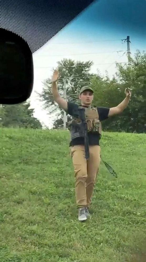 PHOTO: Dmitriy Andreychenko walks downhill with a gun sling and hands in the air before he is apprehended by police near a Walmart in Springfield, Missouri, August 8, 2019, in this still image from video obtained via social media.