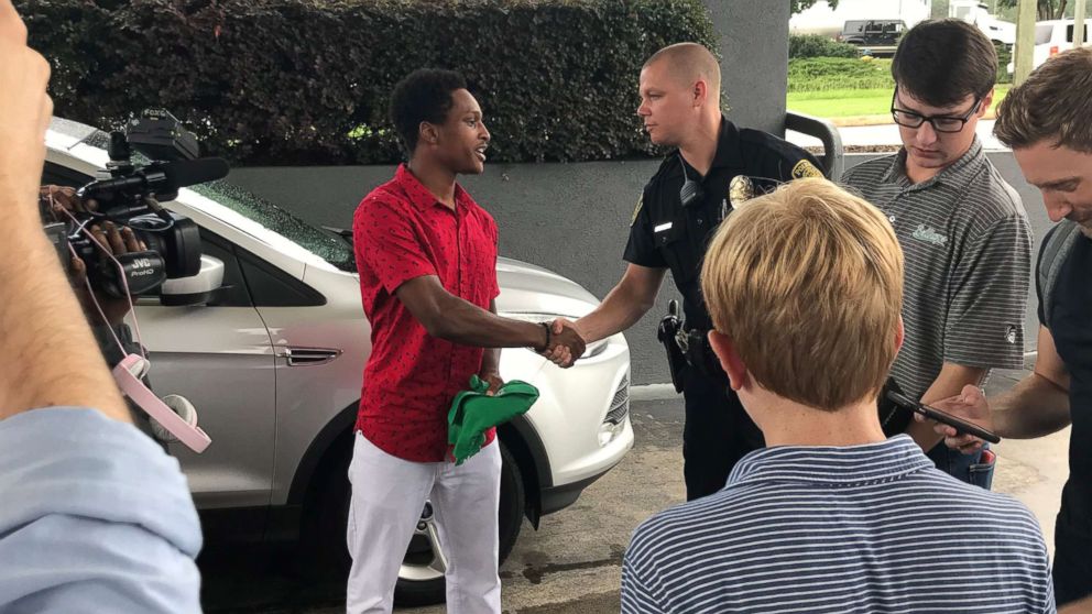 PHOTO: Walter Carr shakes hands with Officer Carl Perkinson who was one of the officers that took Carr to breakfast.