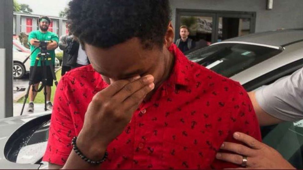 PHOTO: Walter Carr is overcome with emotion after Bellhops CEO Luke Marklin surprised him with a Ford Escape.