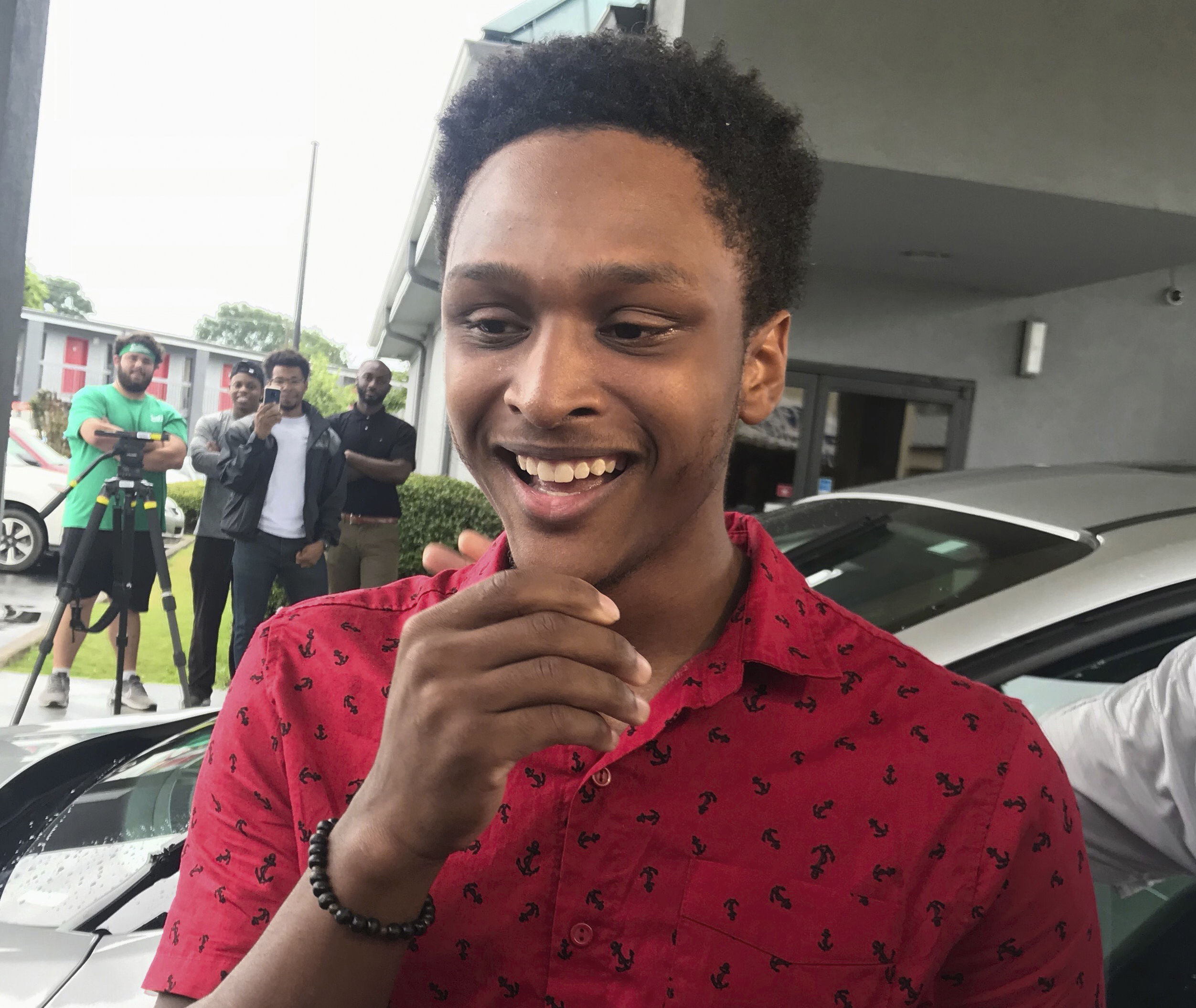 PHOTO: Alabama college student Walter Carr reacts after being given a new car by Bellhops CEO Luke Marklin in Pelham, Ala., July 16, 2018. Carr's car broke down just before his first day of work made the 20-mile journey on foot.
