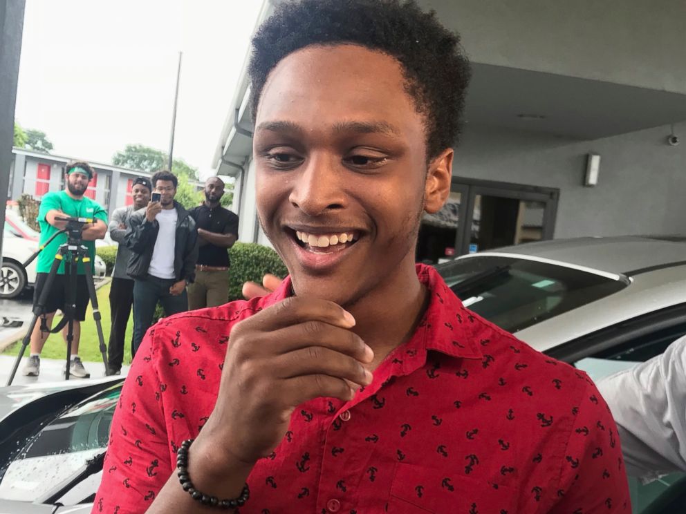 PHOTO: Alabama college student Walter Carr reacts after being given a new car by Bellhops CEO Luke Marklin in Pelham, Ala., July 16, 2018. Carrs car broke down just before his first day of work made the 20-mile journey on foot.