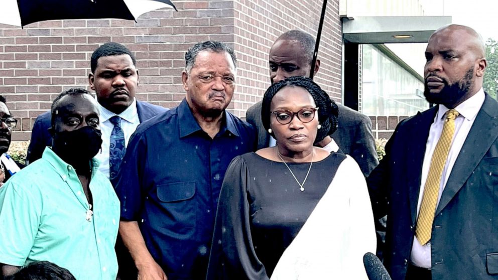 PHOTO: Wanda Cooper-Jones and Marcus Arbery, parents of Ahmaud Arbery, are flanked by Rev. Jesse Jackson and Attorney Lee Merritt while addressing the media following the sentencing of Travis McMichael in federal court in Brunswick, Ga. on Aug. 8, 2022.