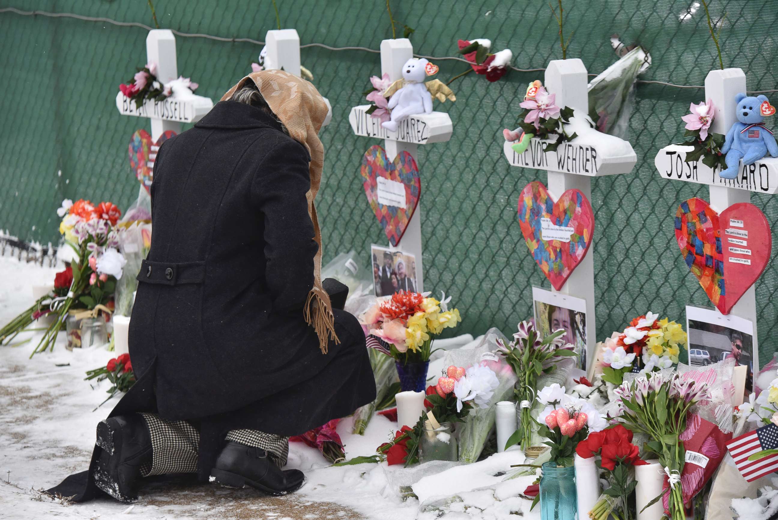 PHOTO: Mourners place a flower at the crosses outside of the Henry Pratt company in Aurora, Ill., Feb. 17, 2019, in memory of the five employees killed on Friday.