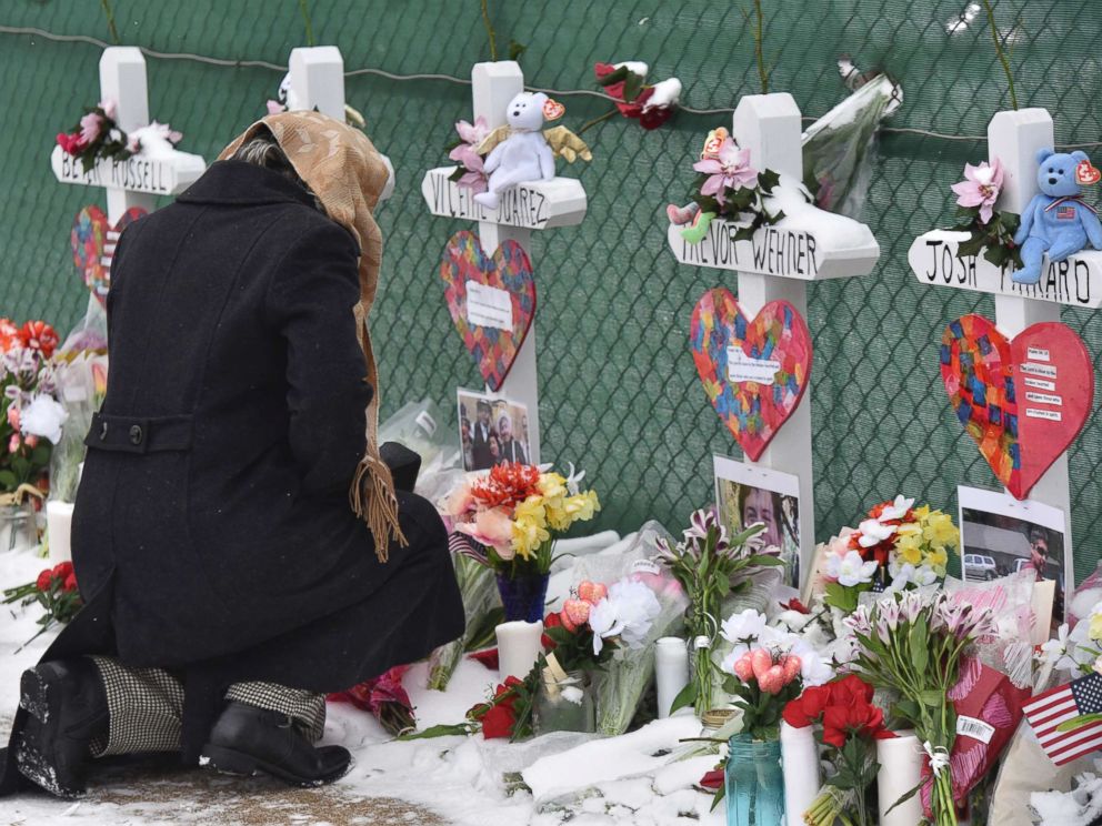 PHOTO: Mourners place a flower at the crosses outside of the Henry Pratt company in Aurora, Ill., Feb. 17, 2019, in memory of the five employees killed on Friday.