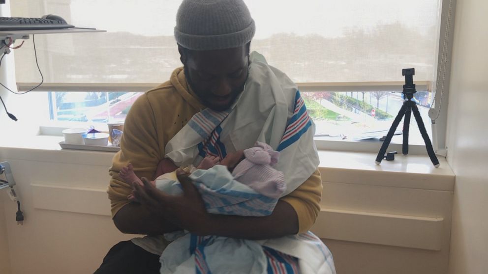 PHOTO: Warner with his newborn daughter Amani.