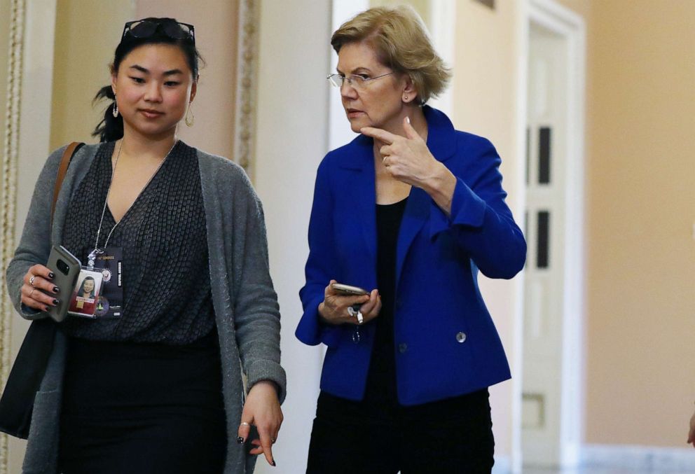 PHOTO: Democratic Presidential Candidate Elizabeth Warren (D-MA), C, walks outside the Senate chamber during a recess in impeachment trial proceedings against President Donald Trump at the U.S. Capitol on January 24, 2020 in Washington, DC. 