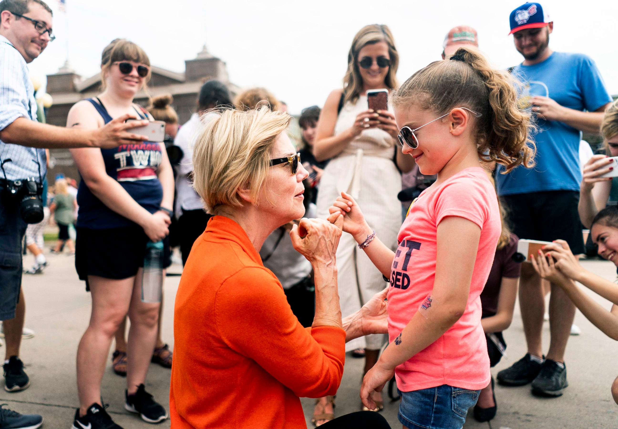 PHOTO: Democratic candidate for President Sen. Elizabeth Warren does a pinky swear with a little girl at the Iowa State Fair in Des Moines, Iowa on Aug. 10, 2019.