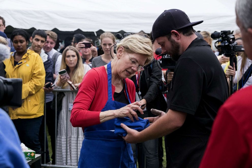 PHOTO: Democratic Presidential candidate Elizabeth Warren signing a apron at the Polk County Democrat Steak Fry in Des Moines, Iowa, Sept. 21, 2019. 