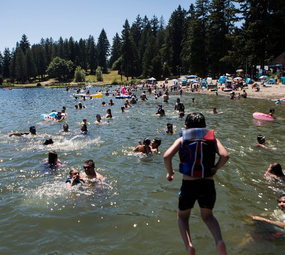PHOTO: People cool off in Silver Lake at Thornton A. Sullivan Park, June 26, 2021, in Everett, Wash.