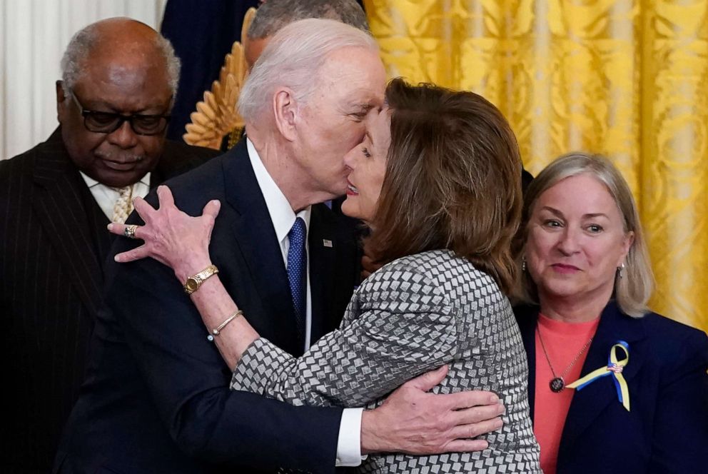 PHOTO: President Joe Biden kisses House Speaker Nancy Pelosi during an Affordable Care Act event in the East Room of the White House in Washington, April 5, 2022.