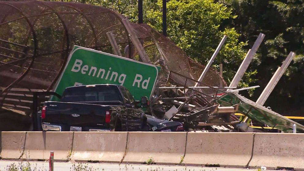 PHOTO: Vehicles sit in debris after a pedestrian bridge collapsed in Washington, D.C., June 23, 2021.