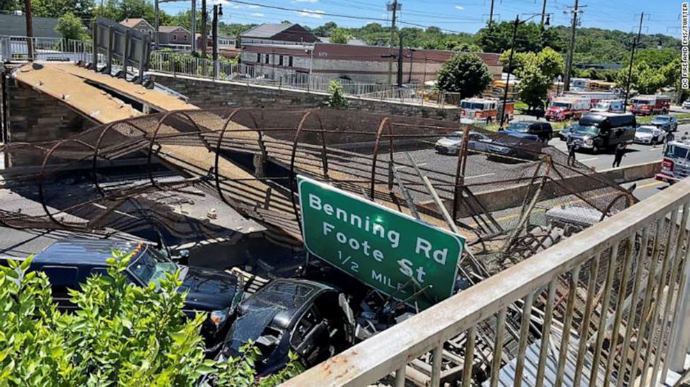 PHOTO: Emergency personnel respond to a crash scene after a pedestrian bridge collapsed onto a roadway in Washington, D.C., June 23, 2021.