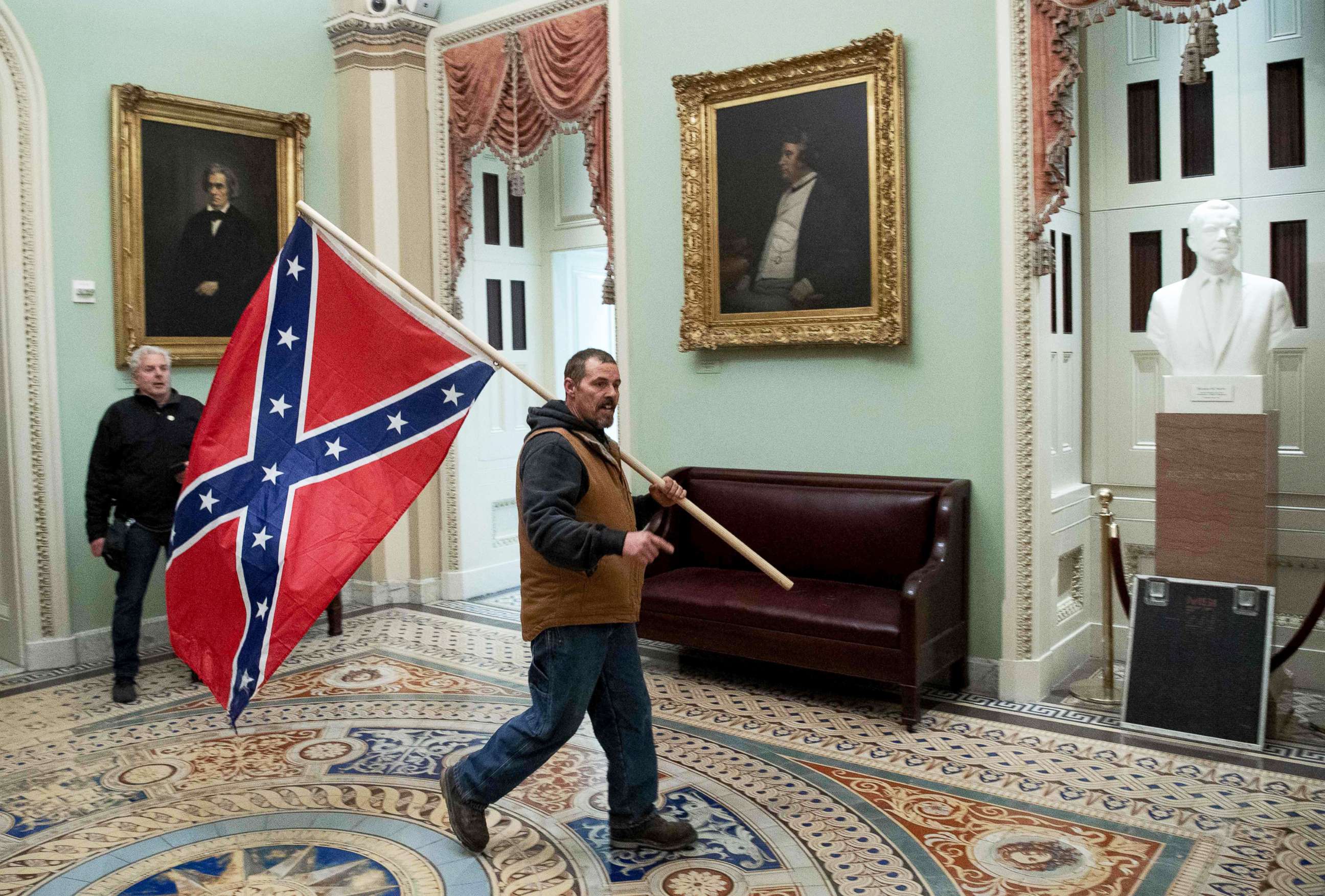PHOTO: A supporter of President Donald Trump that breeched security and entered the U.S. Capitol in protest, carries the Confederate flag, Jan. 6, 2021, in Washington, D.C.