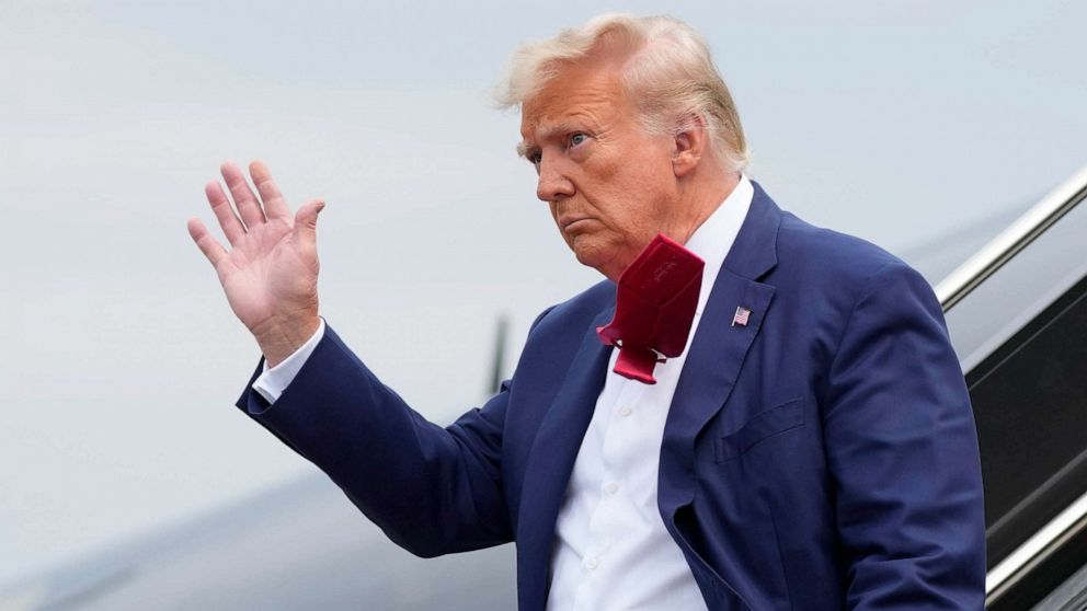 PHOTO: Former President Donald Trump waves as he steps off his plane at Ronald Reagan Washington National Airport, Aug. 3, 2023, in Arlington, Va., as he heads to Washington to face a judge on federal conspiracy charges alleging Trump conspired to