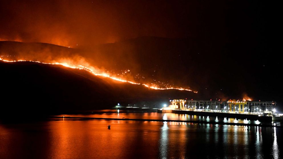 PHOTO: Flames from the Cold Springs Canyon Pearl Hill wildfire encroach on Wells Dam, Monday, Sept. 7, 2020, near Azwell, Wash.