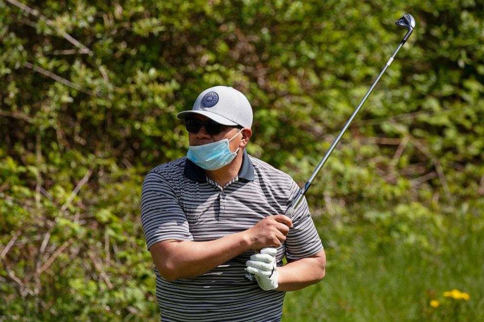 PHOTO: Oscar Castillo golfs at The Golf Club At Newcastle as Gov. Jay Inslee's "Safe Start Washington" begins Phase 1, allowing certain businesses to reopen with restrictions, during the COVID-19 outbreak, in Newcastle, Wash., May 5, 2020. 